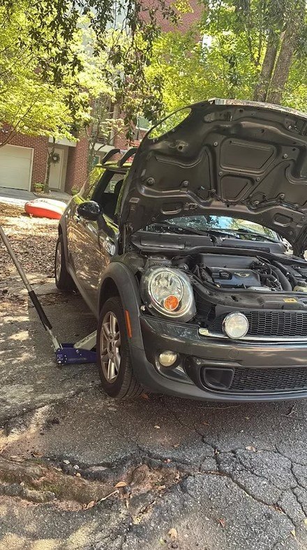Brake caliper and suspension components being repaired